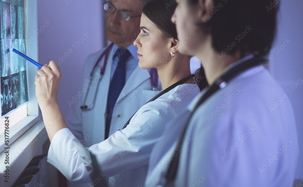 Fototapeta premium Group of doctors examining x-rays in a hospital