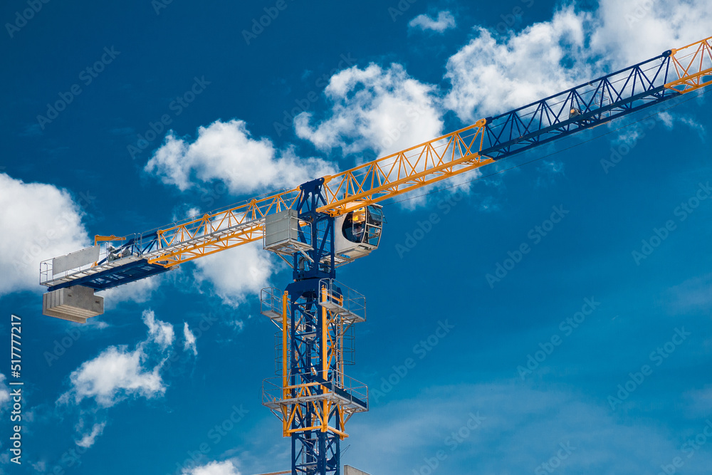 Lifting tower crane at housing construction. Lifting tower crane at housing construction.