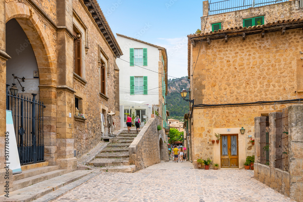 A picturesque street of shops and cafes in the medieval village of Valldemossa, Spain, on the Mediterranean island of Mallorca.