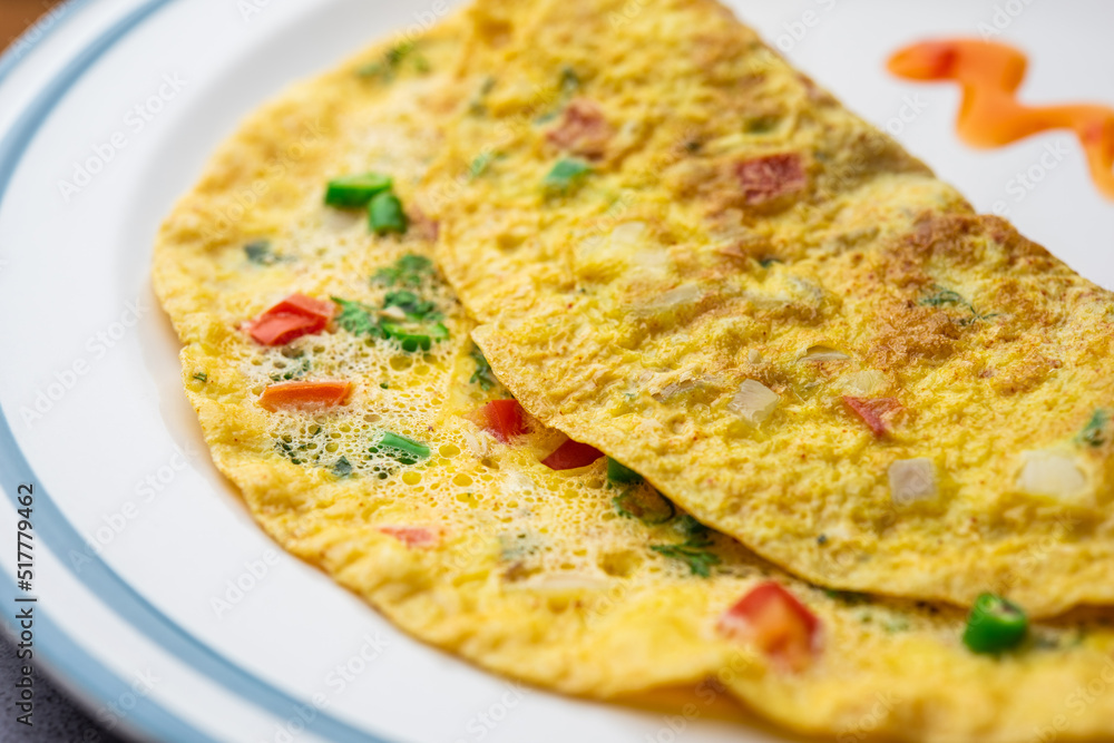 Indian Spiced Masala Omelet filled with fresh vegetable, healthy meal - obrazy, fototapety, plakaty 