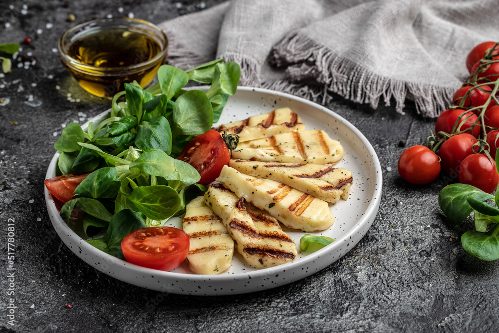 halloumi cheese with mint. alad with grilled halloumi cheese, tomatoes, capers, lettuce and arugula, Cyprus squeaky cheese. top view halloumi cheese with mint. alad with grilled halloumi cheese, tomatoes, capers, lettuce and arugula, Cyprus squeaky cheese. top view