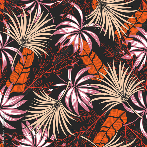 Fashionable seamless tropical pattern with bright plants and leaves on a dark...