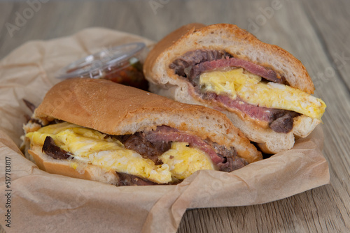 Breakfast steak and scrambled eggs sandwich loaded with protein and wrapped in an Italian roll