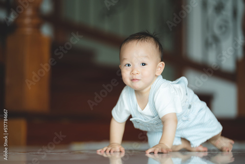 Cute little toddler trying and learning to crawl at home