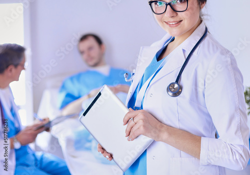 Female doctor using tablet computer in hospital lobby