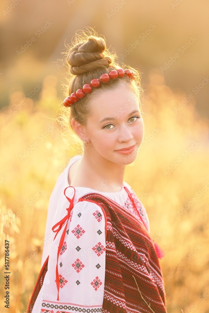 Beautiful Ukrainian girl in national costume vyshyvanka in the field on sunset. Celebrating victory in the war with Russia Beautiful Ukrainian girl in national costume vyshyvanka in the field on sunset. Celebrating victory in the war with Russia