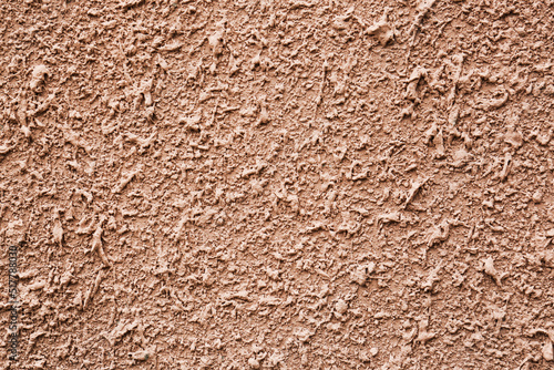 Texture of dark beige plaster wall as background, closeup