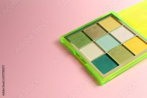 Colorful eyeshadow palette on light pink background. Space for text © New Africa
