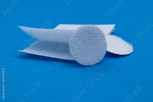 Bild auf Leinwand Hook-and-loop fastener white Velcro in closeup on blue background