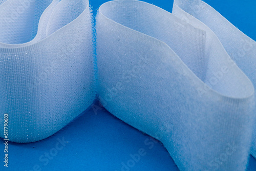 Bild auf Leinwand Hook-and-loop fastener white Velcro in closeup on blue background
