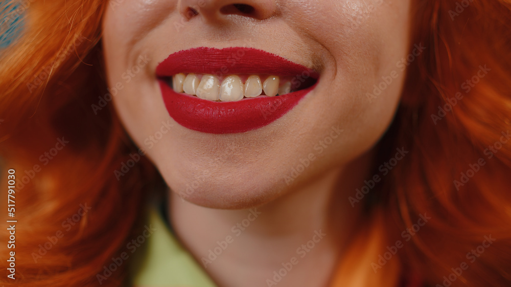 Portrait close-up of young happy redhead woman smile mouth, charming lovely ginger girl with perfect white great healthy teeth close up. Red lipstick. Female skincare model smiles wide for camera Portrait close-up of young happy redhead woman smile mouth, charming lovely ginger girl with perfect white great healthy teeth close up. Red lipstick. Female skincare model smiles wide for camera