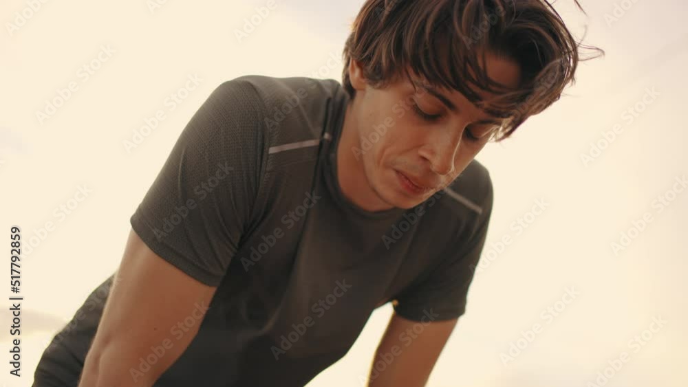 exhausted young male athlete after jog or training outdoors, portrait of man against sky exhausted young male athlete after jog or training outdoors, portrait of man against sky
