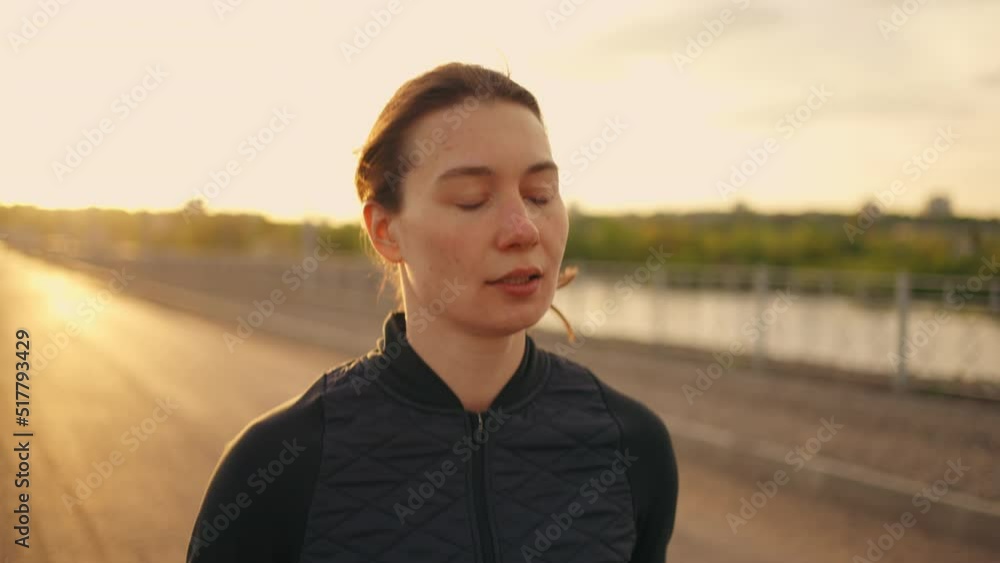 portrait of running woman, female athlete is jogging in morning, pretty lady is training outdoors