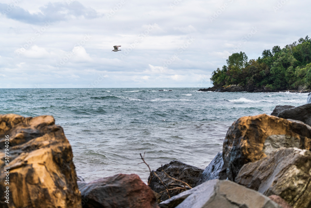 Rough waves that break with the stones on the sea shore Rough waves that break with the stones on the sea shore