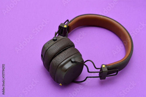 wireless headphones in a classic style on purple background