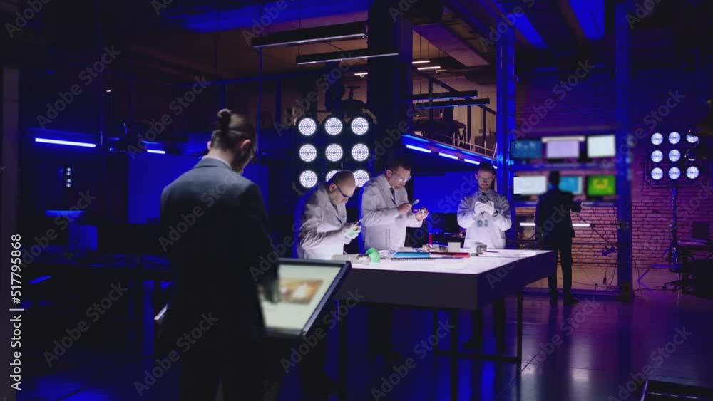 Professional scientists in white coats working inside modern futuristic laboratory . Construction experts doing experiment . Physicist or seismologist working inside lab . Scientific equipment Professional scientists in white coats working inside modern futuristic laboratory . Construction experts doing experiment . Physicist or seismologist working inside lab . Scientific equipment