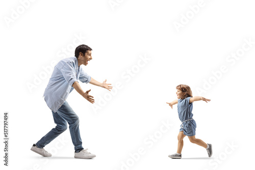 Father and little girl running towards each other to hug