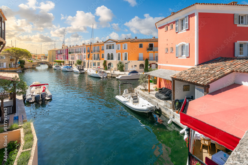 Obraz premium Colorful homes with boats and docks along the canals at the oceanfront community of Port Grimaud, France, along the French Riviera Cote d'Azur near Saint-Tropez.