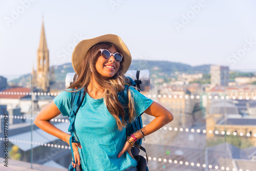 Portrait of a traveler girl with travel backpack smiling enjoying vacation