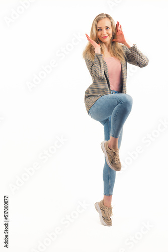 Vertical isolated full body shot of a posing on one leg blond caucasian young adult woman. Copy space. White background. High quality photo