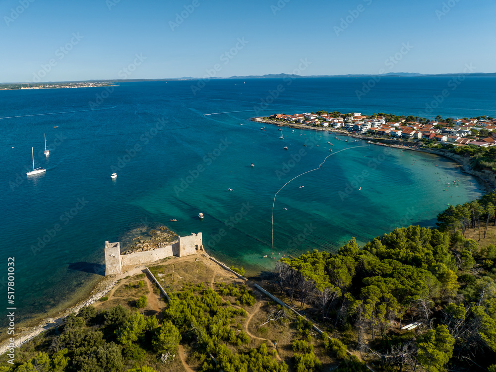 Croatia - The amazing Vir island with an old castle near the sea from drone view