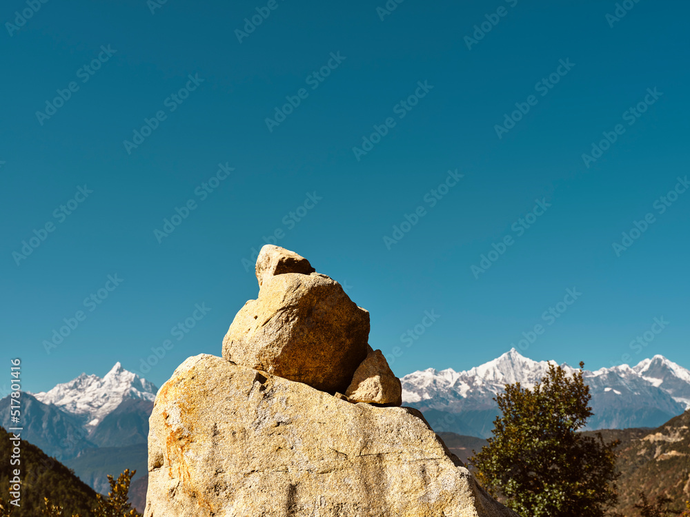 huge prayer stone with meili snow mountain in background in china's yunnan province