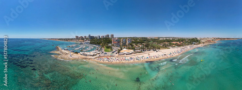 Panoramic view of Dehesa de Campoamor beach, Alicante during sunny summer day. Costa Blanca. Spain. Travel and tourism concept. photo