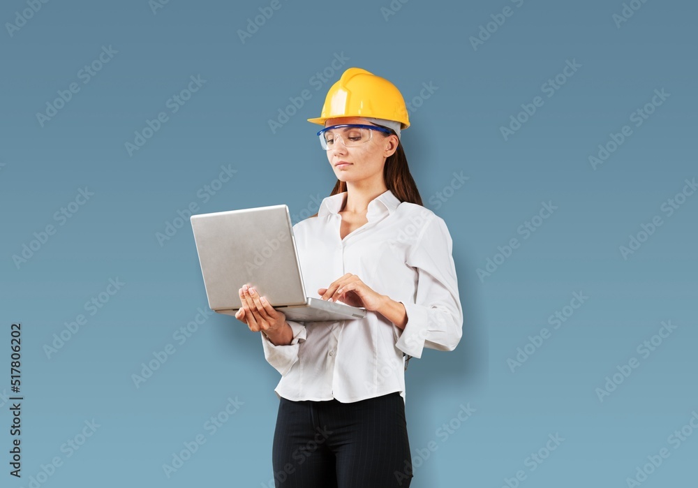 Young female engineer with a safety hardhat posing Young female engineer with a safety hardhat posing