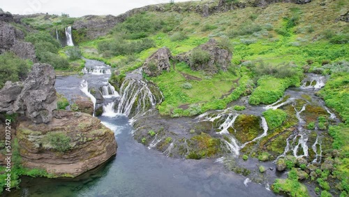 View of Gjáin waterfall and natural creek in Þjórsárdalur valley at South of Icelandic Highlands photo