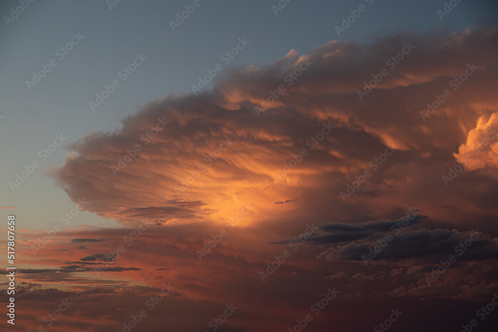 Orange Cumulonimbus Clouds Lit By Evening Sunset