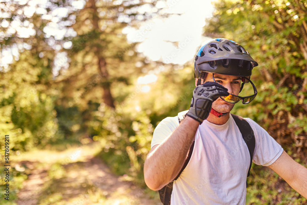 The cyclist prepares to ride the bike on extreme and dangerous forest roads The cyclist prepares to ride the bike on extreme and dangerous forest roads