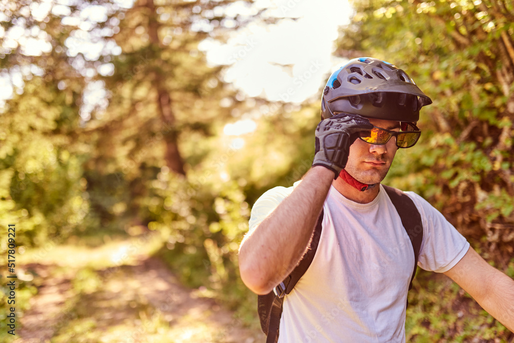 Fototapeta premium The cyclist prepares to ride the bike on extreme and dangerous forest roads