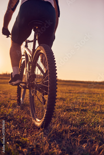 Close-up photo of a cyclist riding a bike on top of a mountain