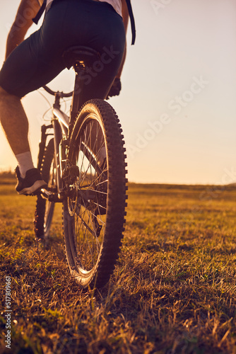 Close-up photo of a cyclist riding a bike on top of a mountain
