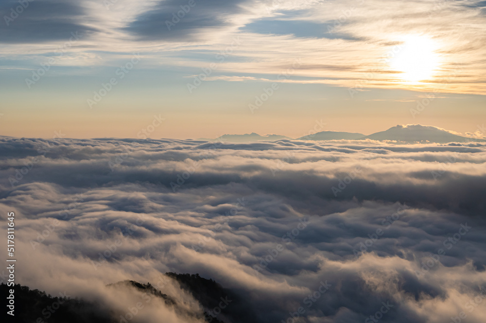 雲から透かして照らす朝日と雲海。日本の北海道の津別峠で。