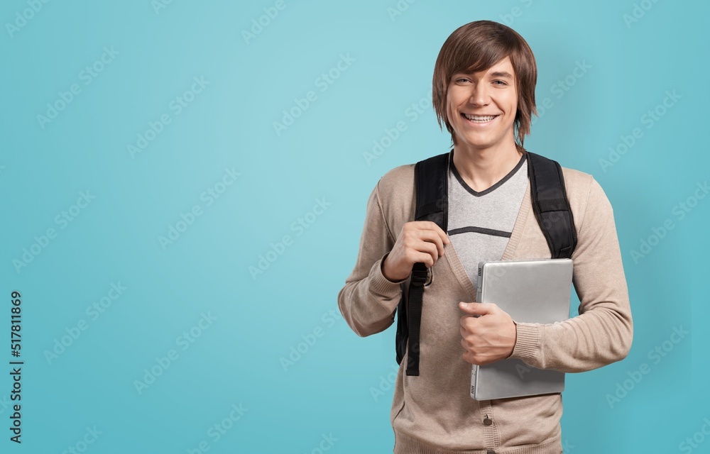Optimistic male student or worker using laptop pc Optimistic male student or worker using laptop pc