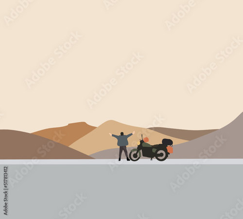 Man with motorcycle standing on the highway road looking at mountain landscape during road trip. Enjoying freedom and active lifestyle