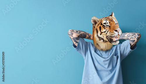 Tattooed man with head of tiger on blue background