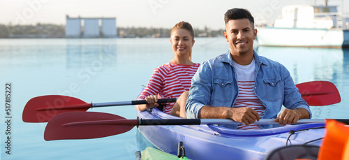 Young couple kayaking in ri...