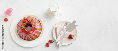 Tasty strawberry cake with jug of milk on white background, top view