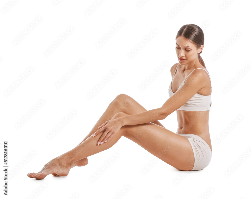 Young tanned woman in underwear sitting on white background Young tanned woman in underwear sitting on white background