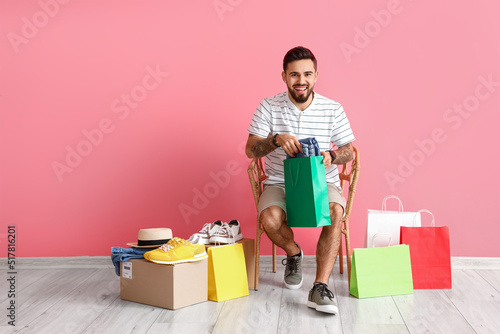 Happy young man sitting on ...