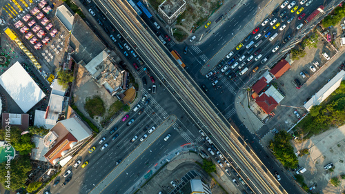 Aerial view Automobile cars drive at cross road in the City Town. Skycrapers buildings at downtown streets. Business center City Roads Traffic road Junction Freeway transportation logistics concept.
