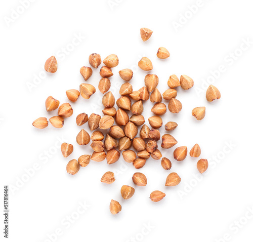 Buckwheat grains scattered on white background