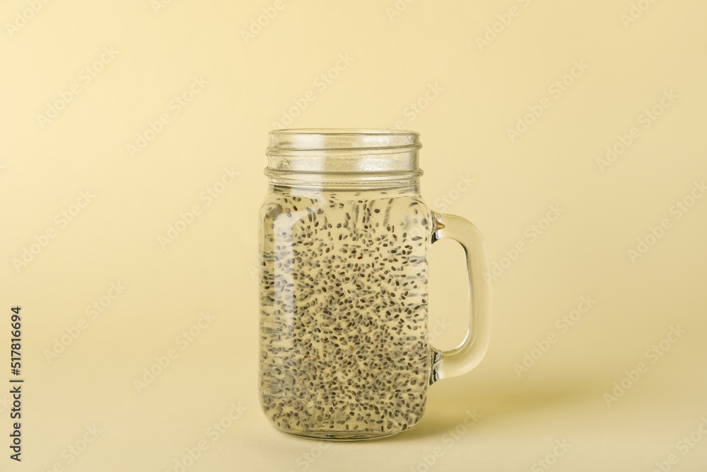 Mason jar of water with chia seeds on color background Mason jar of water with chia seeds on color background