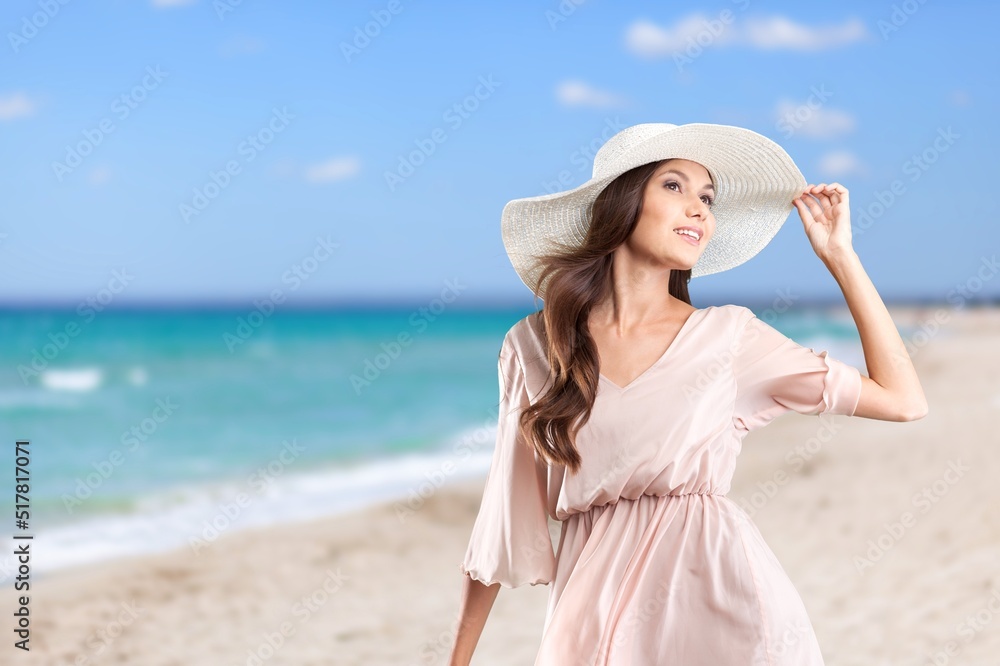 Luxury beach vacation elegant tourist woman walking relaxing at the beach. Lady tourist on holiday vacation resort Luxury beach vacation elegant tourist woman walking relaxing at the beach. Lady tourist on holiday vacation resort
