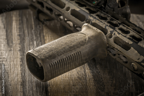 Close up of khaki camouflage fore hand grip ar assault rifle weapon firearm photo