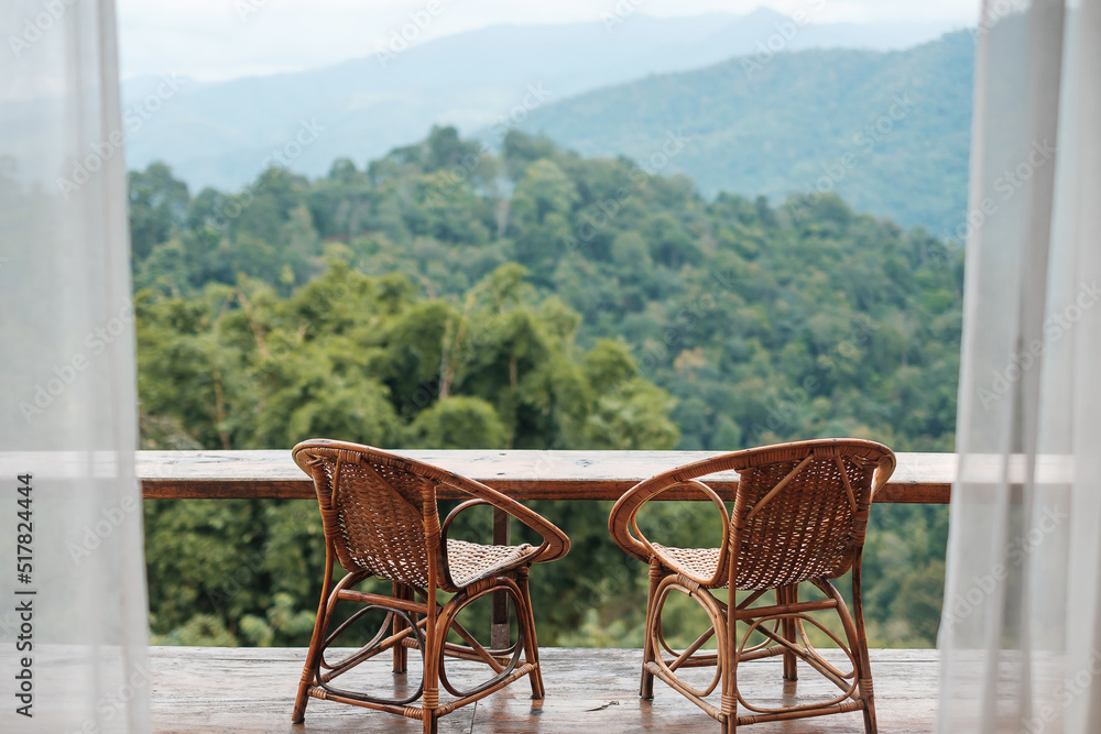 Couple chairs on balcony of countryside home or homestay with mountain view background in the morning