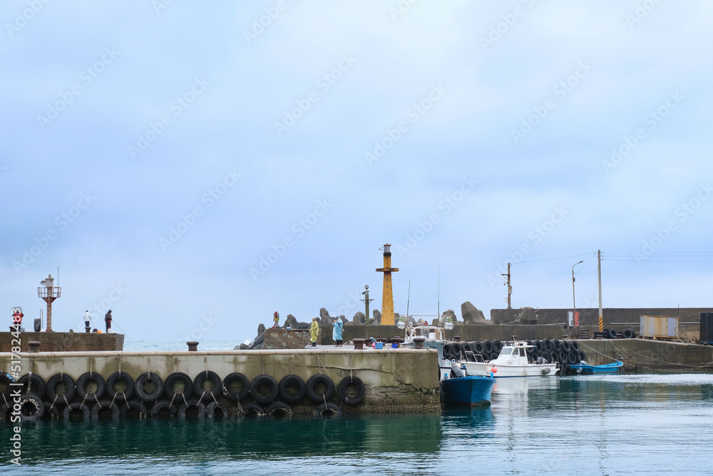 Fototapeta premium Fishing village full of anchored fishing boat in cloudy day