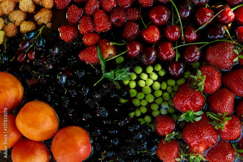 Fototapeta Naklejka Na Ścianę i Meble -  Fresh seasonal fruits and berries: strawberries, apricots, cherries, mulberry, raspberry under natural light. Healthy food, natural dessert, organic food.
